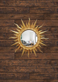 Handmade gold patina sunburst wall mirror on wood wall, 24.5 cm