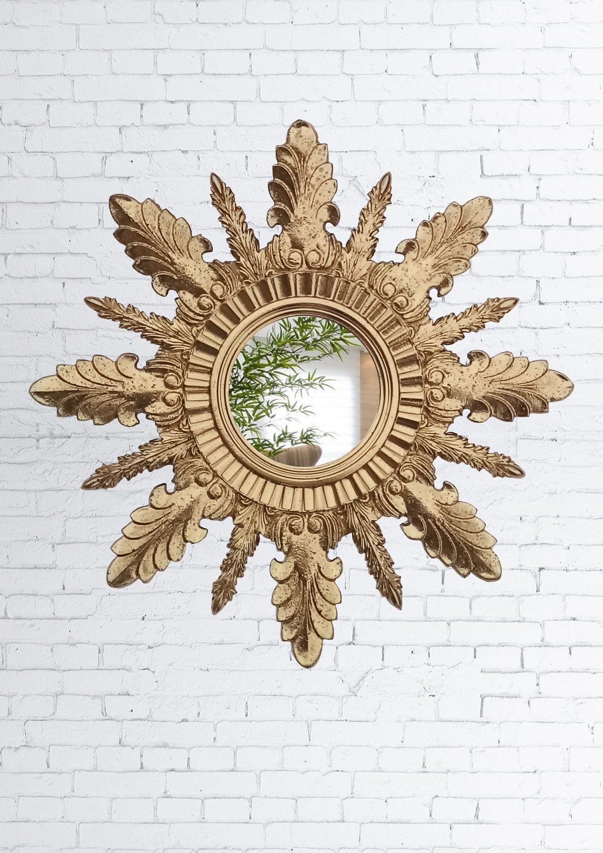Handmade gold sunburst wall mirror on white brick wall, 37 cm